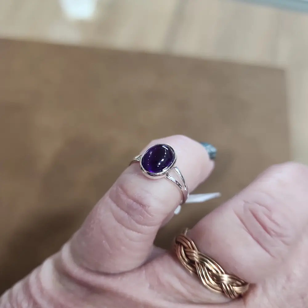 Assorted sterling silver rings featuring unique genuine gemstones in various shapes and colors, displayed on a white background. Perfect for crystal energy, personal style, and one-of-a-kind magic.