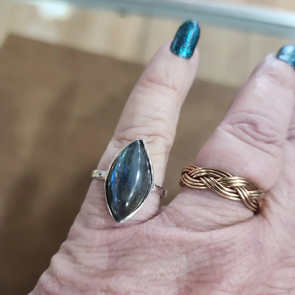 Assorted sterling silver rings featuring unique genuine gemstones in various shapes and colors, displayed on a white background. Perfect for crystal energy, personal style, and one-of-a-kind magic.