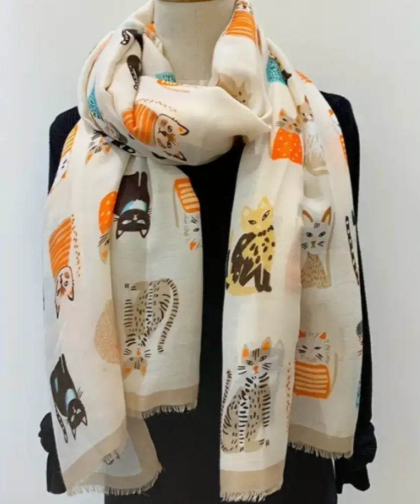 Scarf with cat pattern draped over a mannequin against a white background